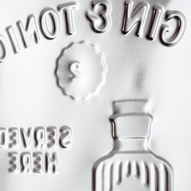 Close-up of a bottle label with embossed design and text.