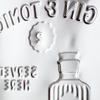 Close-up of a bottle label with embossed design and text.
