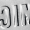 Embossed letters on a textured surface with 